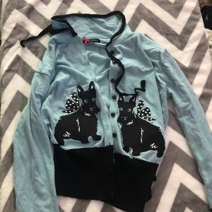 Blue cardigan with dogs in it.